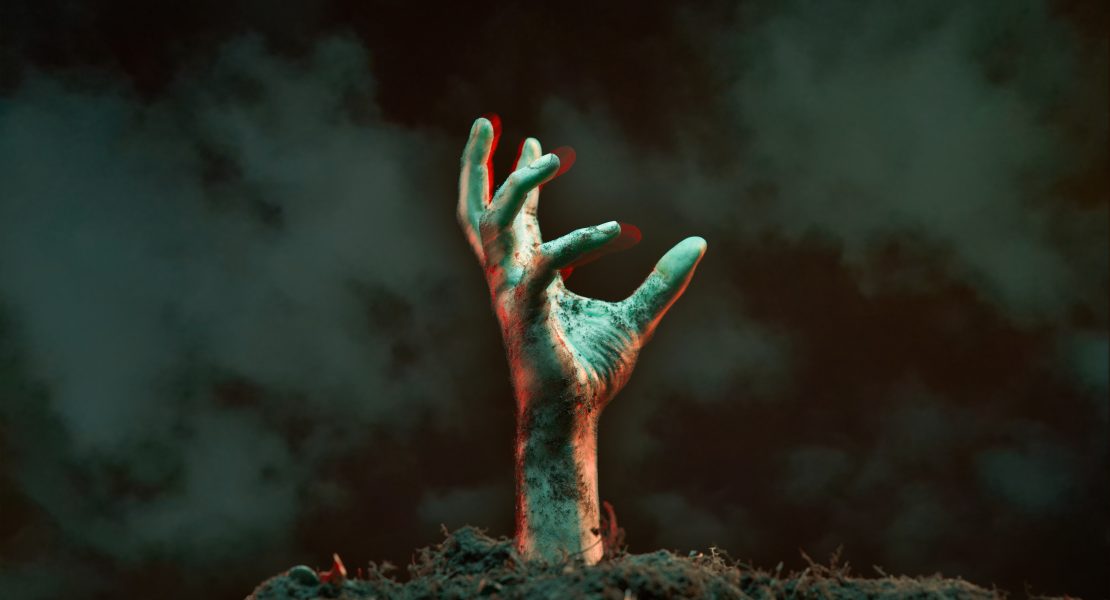 Image of zombie hand sticking out of grave.